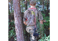 Person in full camouflage gear with a bow and arrow, standing in a wooded area.