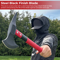 Person holding a black axe with red handle outdoors