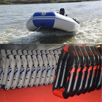 Inflatable boat being pulled by a rope on water with a row of similar boats and oars in the foreground.