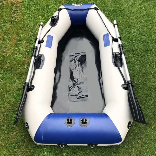 Inflatable kayak with blue and white design on a grassy background