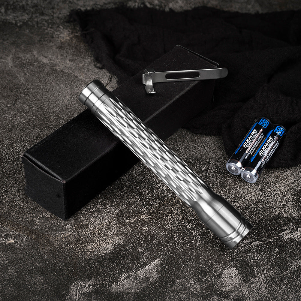 Metal tool with textured handle on a dark surface