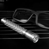 Flashlight on car dashboard with sunglasses in the background
