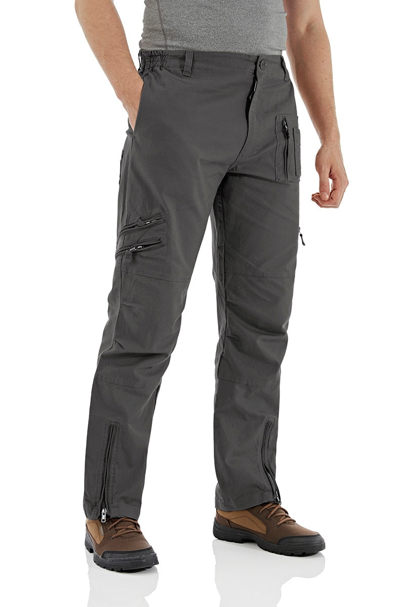 Gray hiking pants with multiple pockets and zippers on a white background